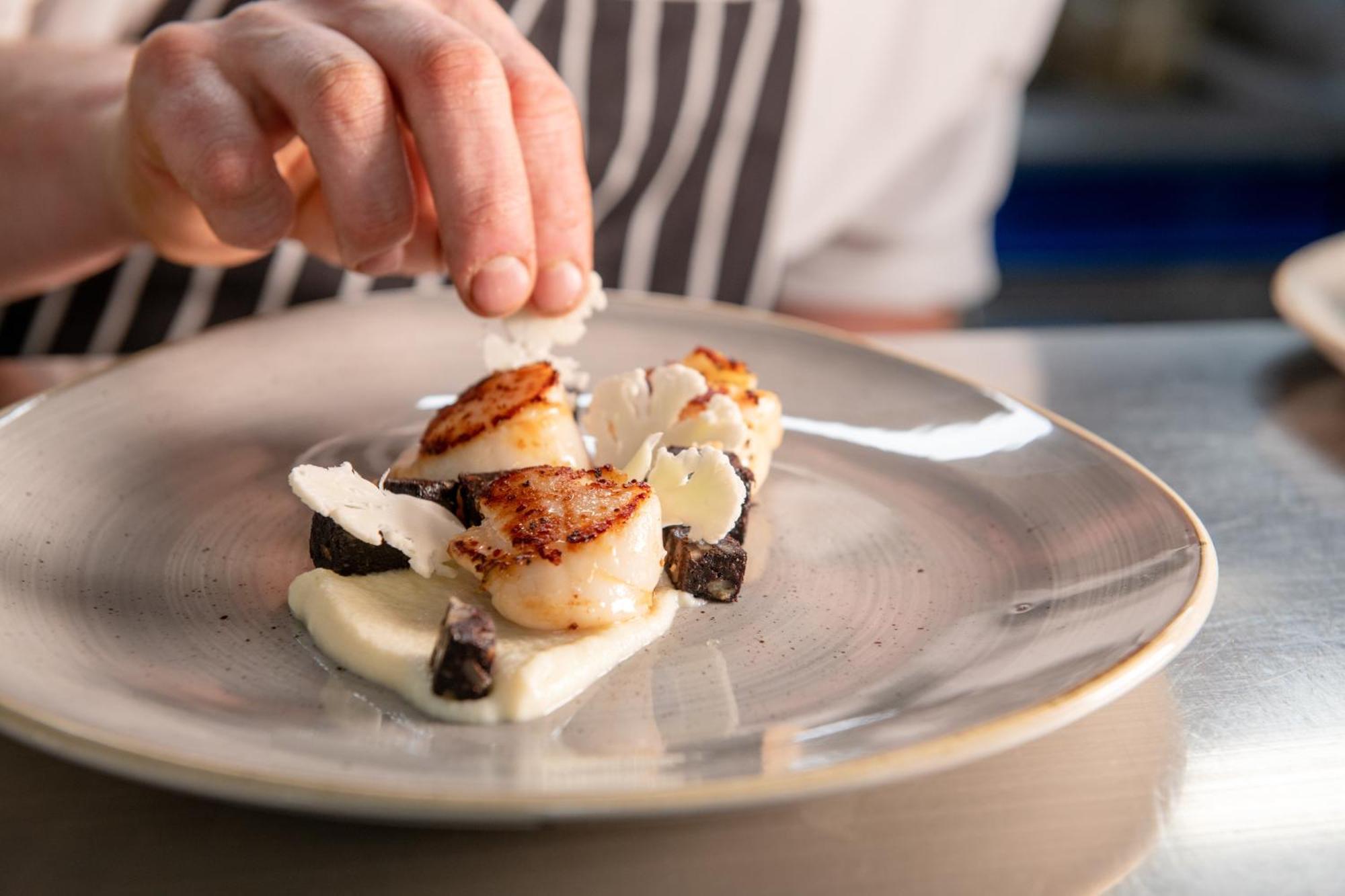 Hotel The Millstone, Mellor Blackburn  Esterno foto A chef finishing a plate of scallops